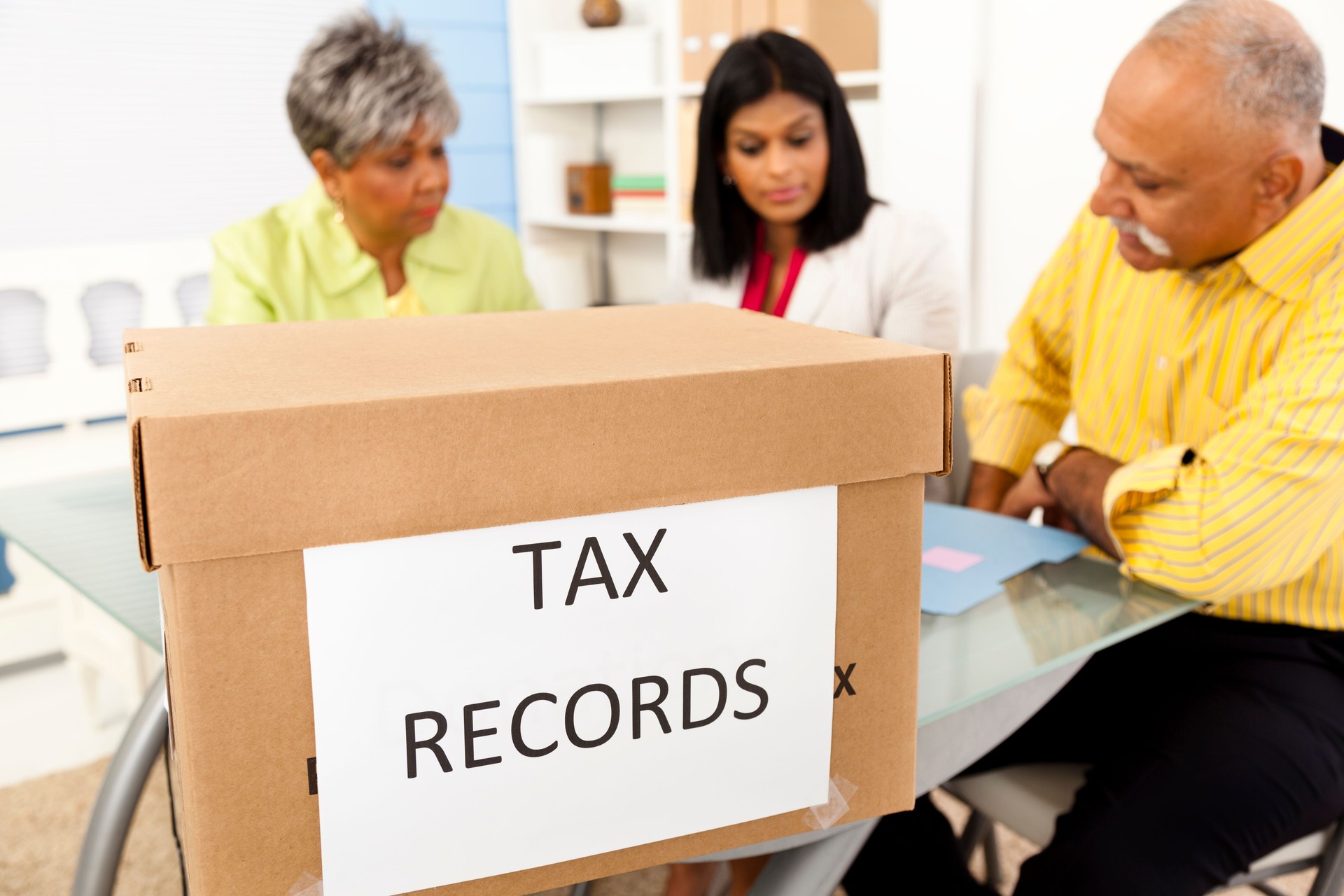 Services: Office accountants working on box of tax records